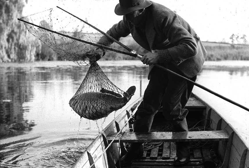 Dick Walker hauls his catch on board the famous Redmire punt